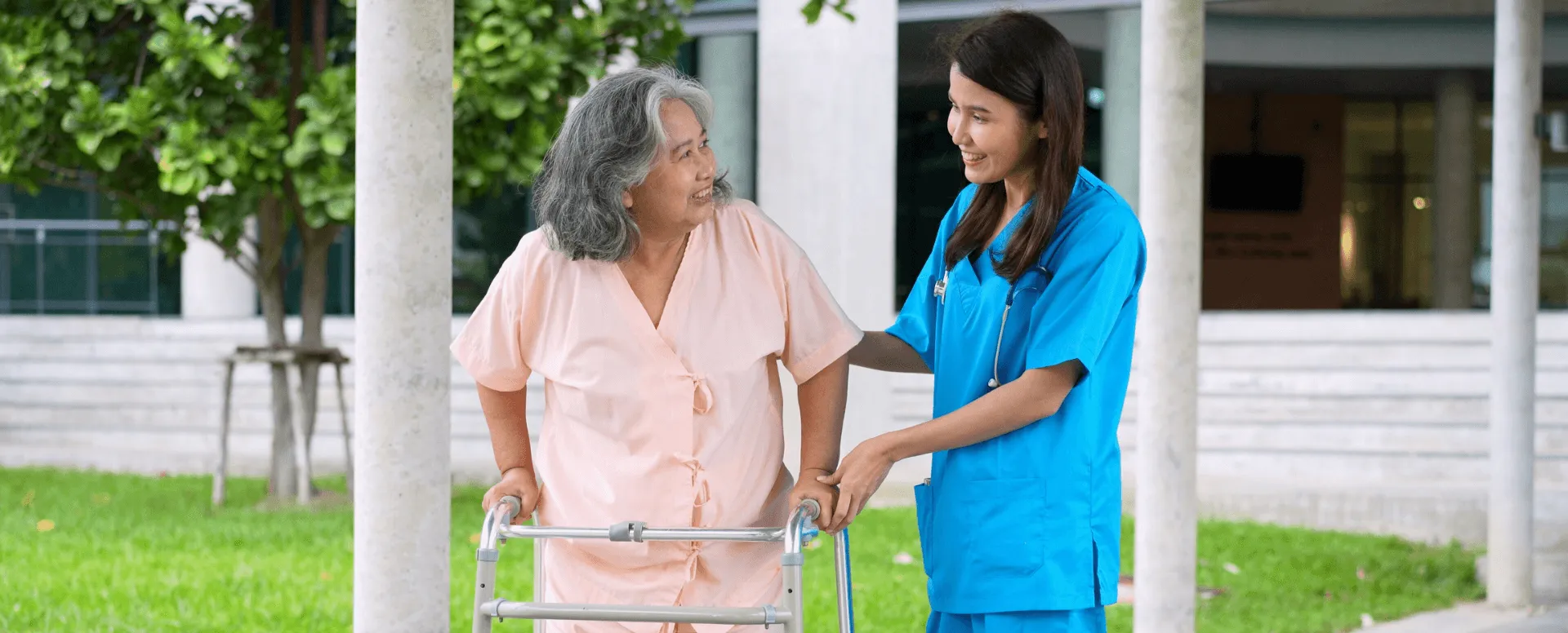 medical professional helping elderly person with a walker