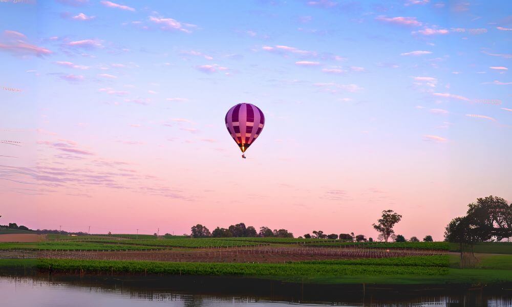 Hot air balloon over Hunter Valley at sunset