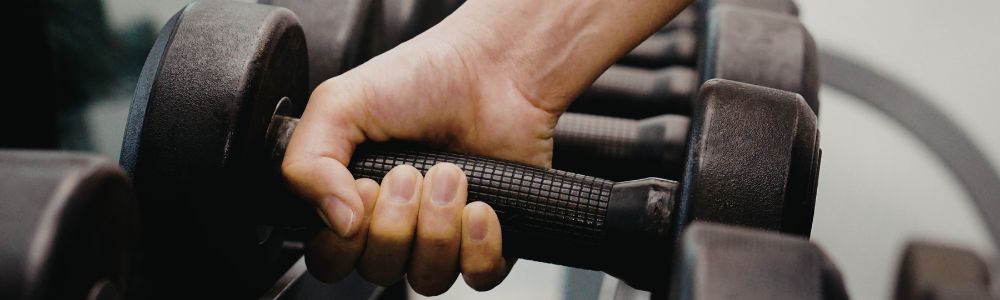 hand holding gym dumbbell
