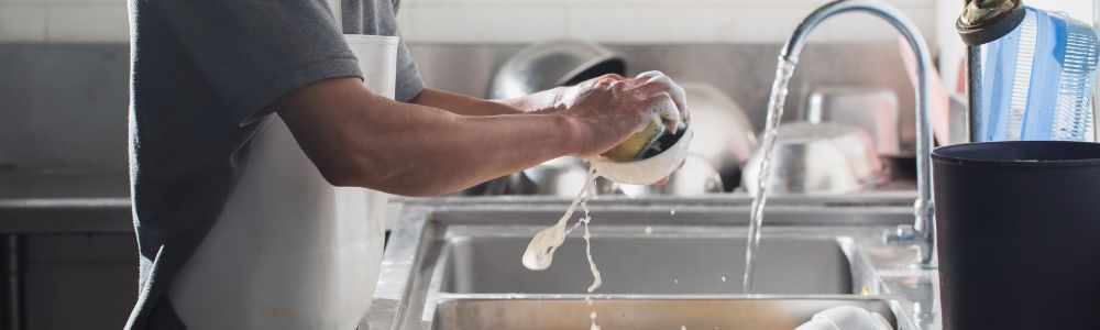 man washing dishes